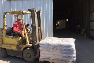Tim is unloading bean seed from tractor trailer.